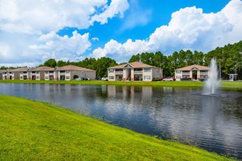 Apartment buildings with a view of the pond.